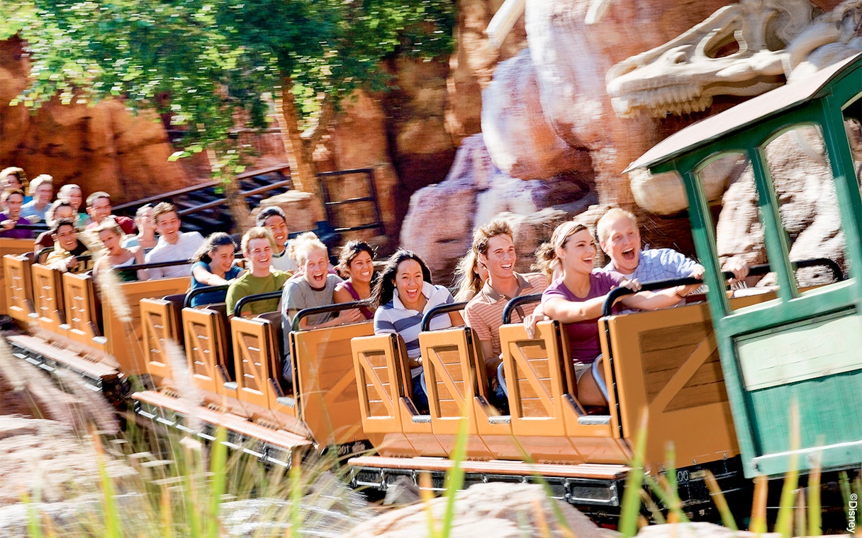 Visitors enjoying a roller coaster ride at Frontierland, Disneyland Park, California.