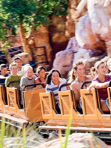 Visitors enjoying a roller coaster ride at Frontierland, Disneyland Park, California.