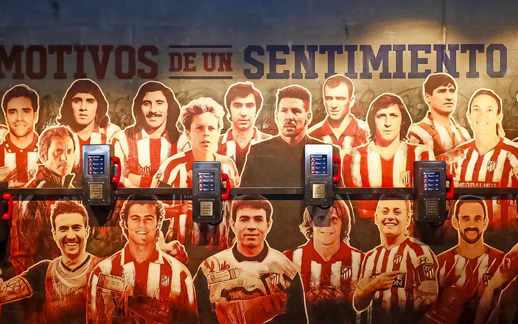Atletico de Madrid Stadium mural featuring legendary players, part of the stadium tour and museum experience.