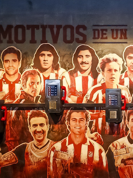 Atletico de Madrid Stadium mural featuring legendary players, part of the stadium tour and museum experience.