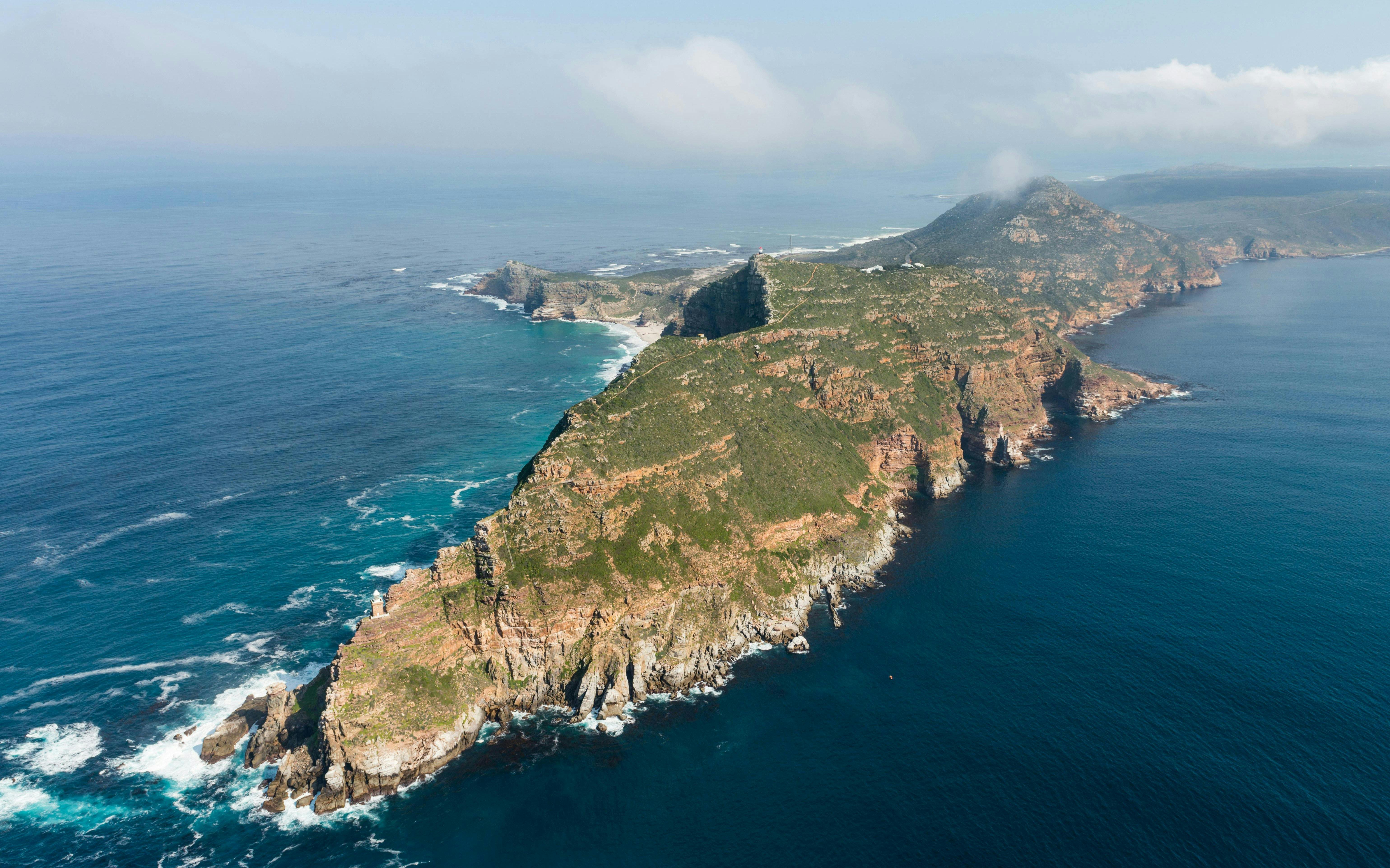 Aerial view of Cape Point and Cape of Good Hope, South Africa, with rugged cliffs and ocean.