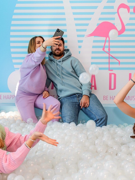 Visitors enjoying a ball pit inside Be Happy Museum in Krakow.