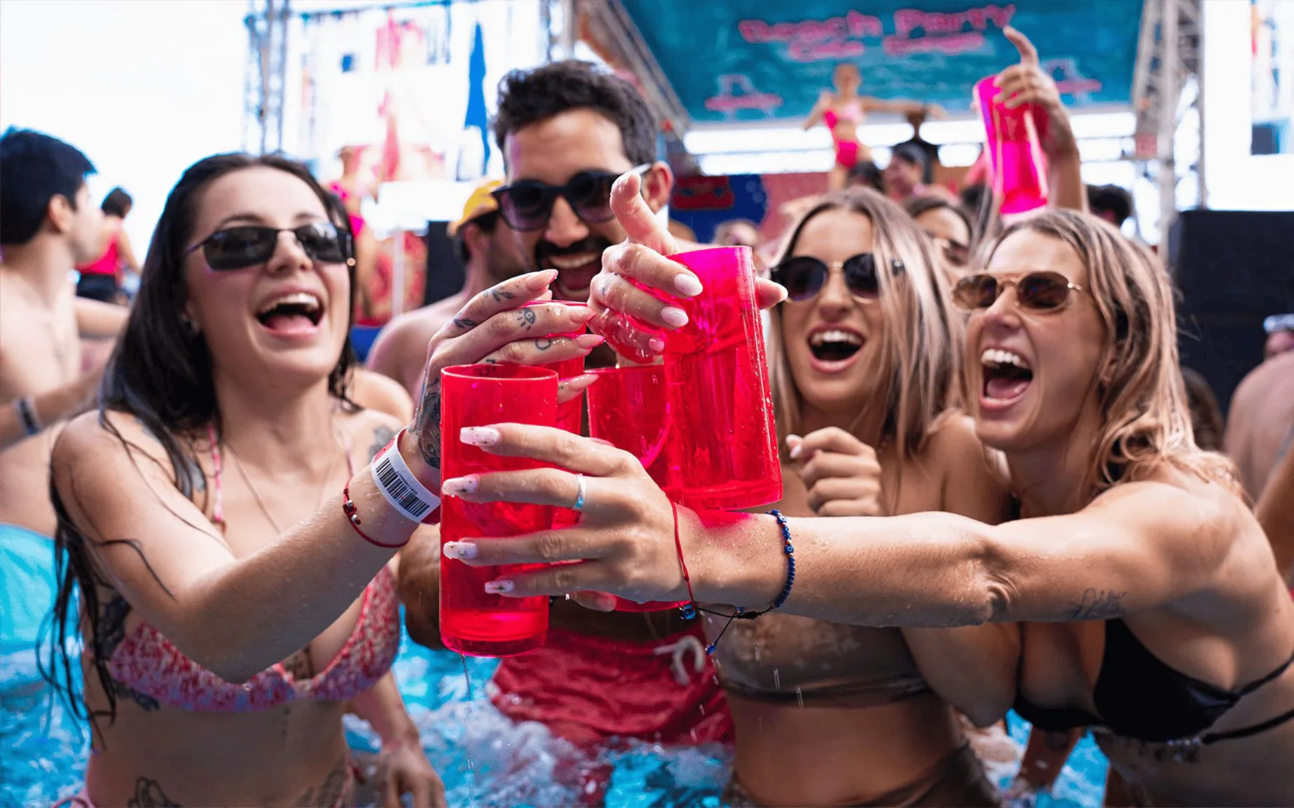 Partygoers enjoying drinks at Coco Bongo Beach Party.