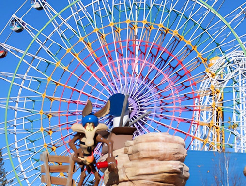 Ferris wheel and cartoon character statue at FujiQ Highland, Japan.