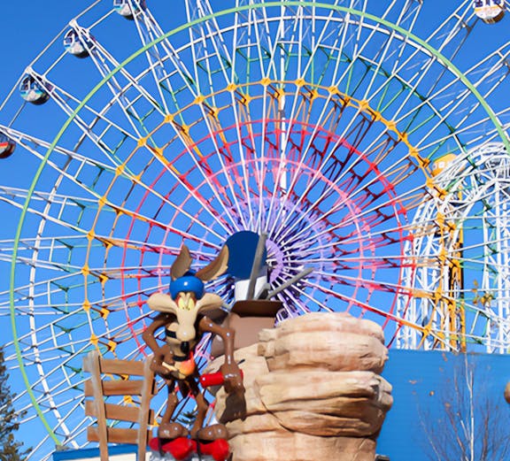 Ferris wheel and cartoon character statue at FujiQ Highland, Japan.