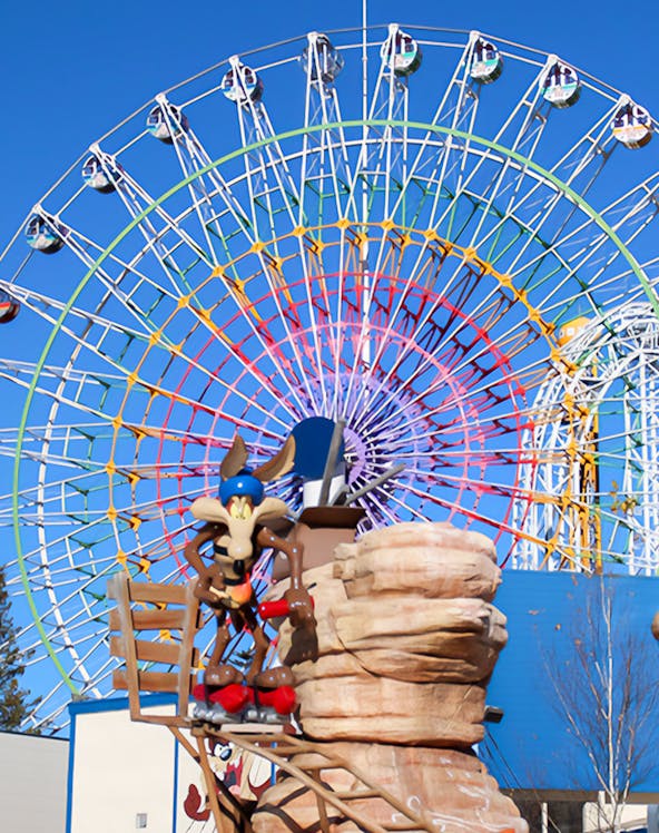 Ferris wheel and cartoon character statue at FujiQ Highland, Japan.
