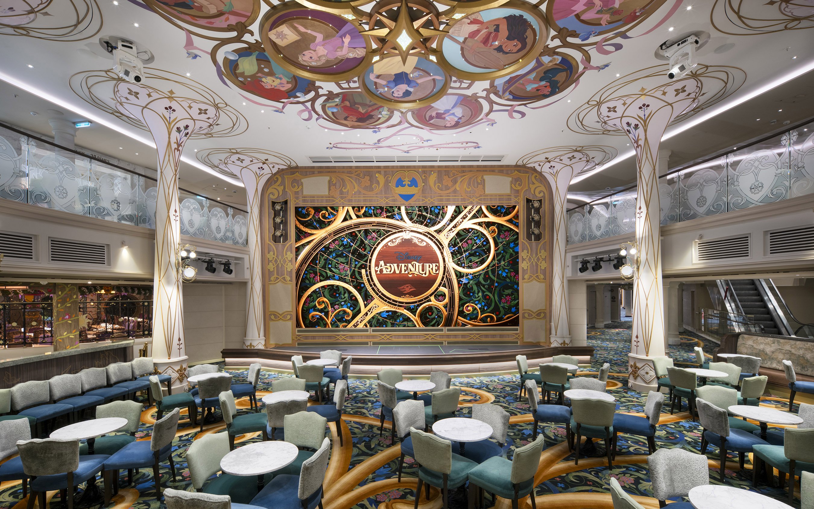 Disney Cruise Line Town Square with ornate stage and colorful seating area.