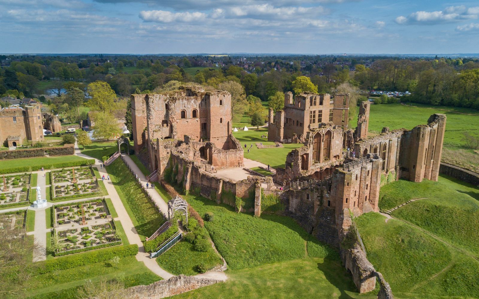 Aerial view of Kenilworth Castle in Warwickshire, England, showcasing its historic ruins and surrounding landscape.