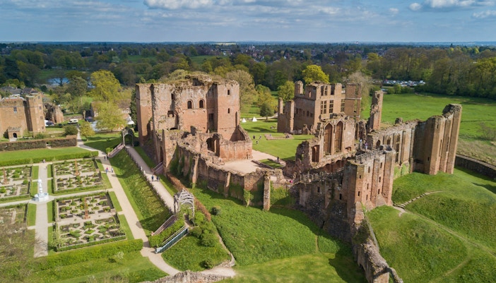 Aerial view of Kenilworth Castle in Warwickshire, England, showcasing its historic ruins and surrounding landscape.
