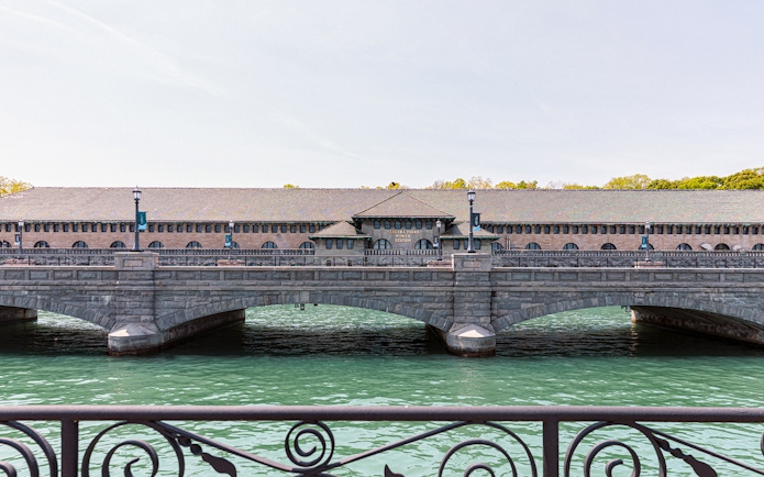 Niagara Power Station exterior with arched bridge over water.