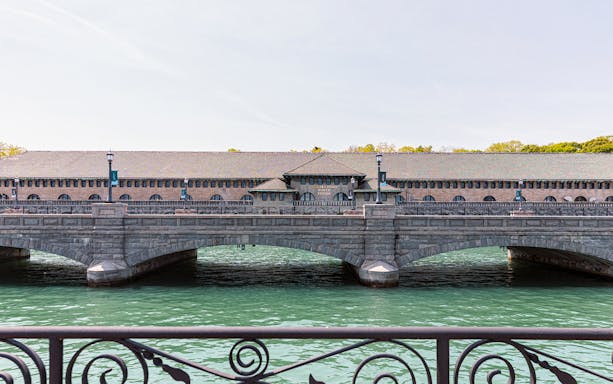 Niagara Power Station exterior with arched bridge over water.