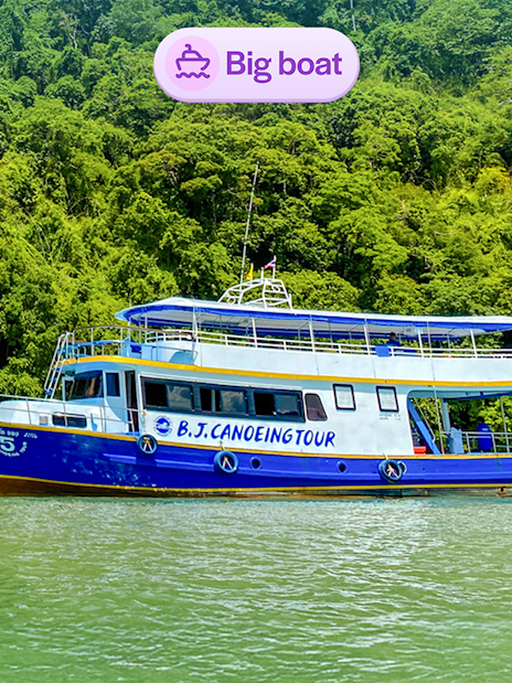 Tourists canoeing near a tour boat at Phang Nga Bay, Thailand.
