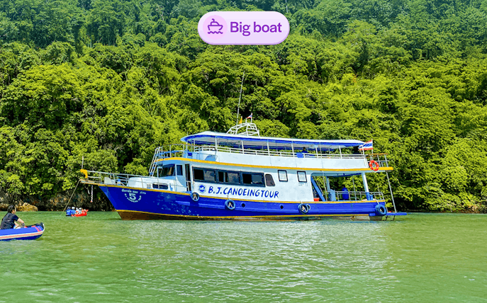 Tourists canoeing near a tour boat at Phang Nga Bay, Thailand.