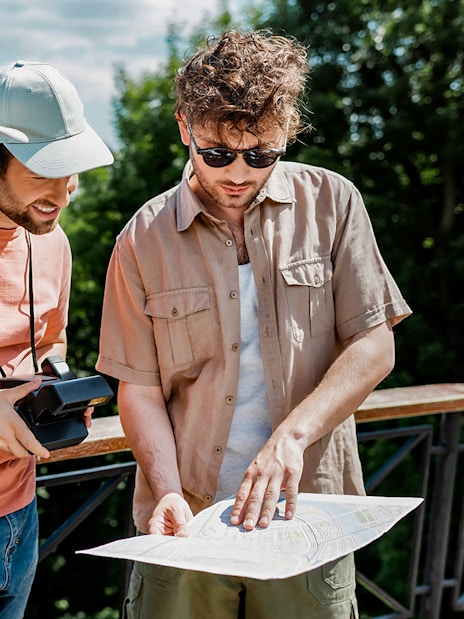 Tourists examining a map during Mostar and Kravice Falls day tour.