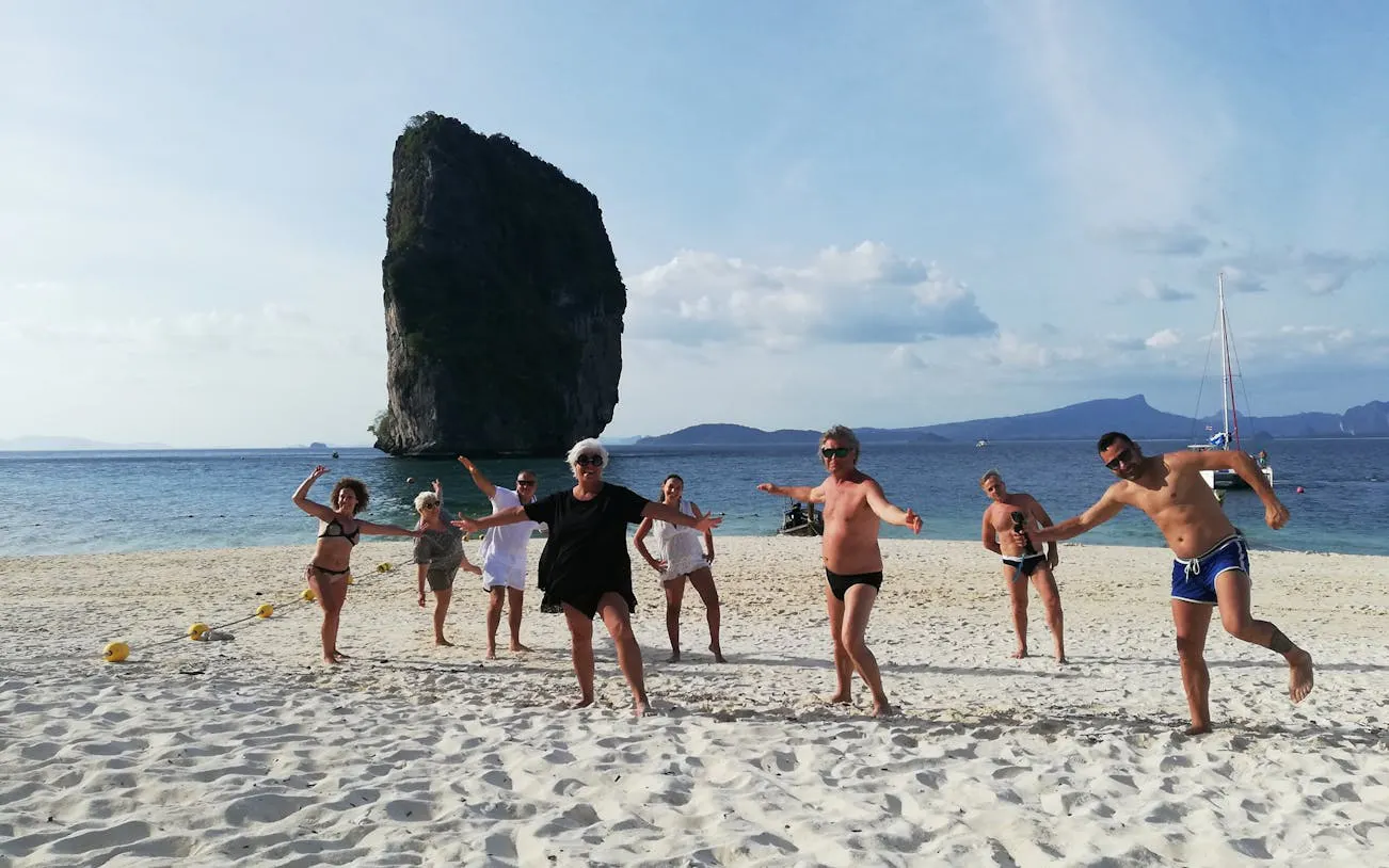 Group enjoying beach with limestone rock in Krabi during 4 Islands Sunset Speedboat Tour.