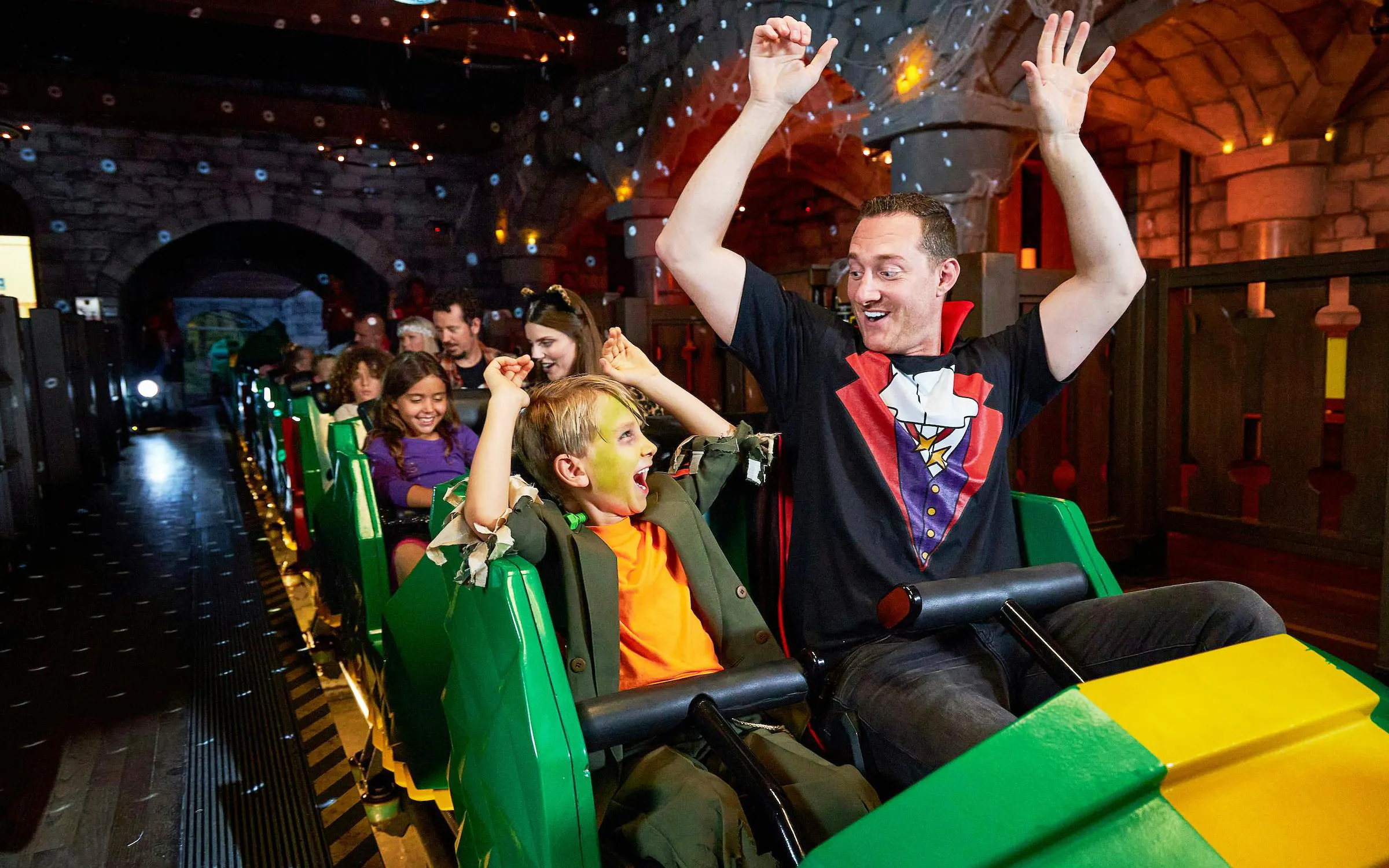 Visitors on a ride at Legoland New York during Halloween event.