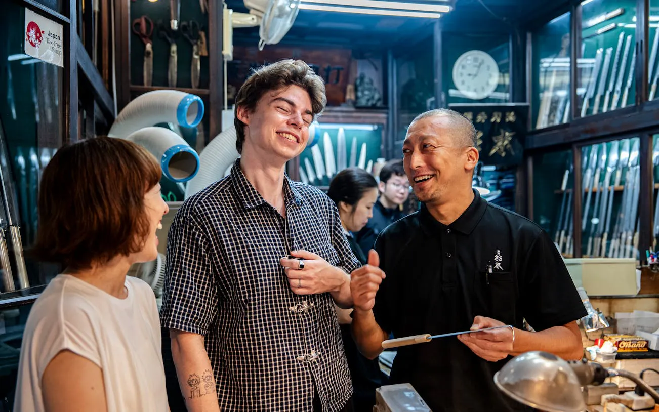 Visitors enjoying a knife shop tour in Tsukiji Market, Tokyo.