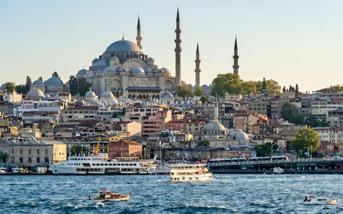 Süleymaniye Mosque overlooking the Bosphorus with boats in Istanbul.