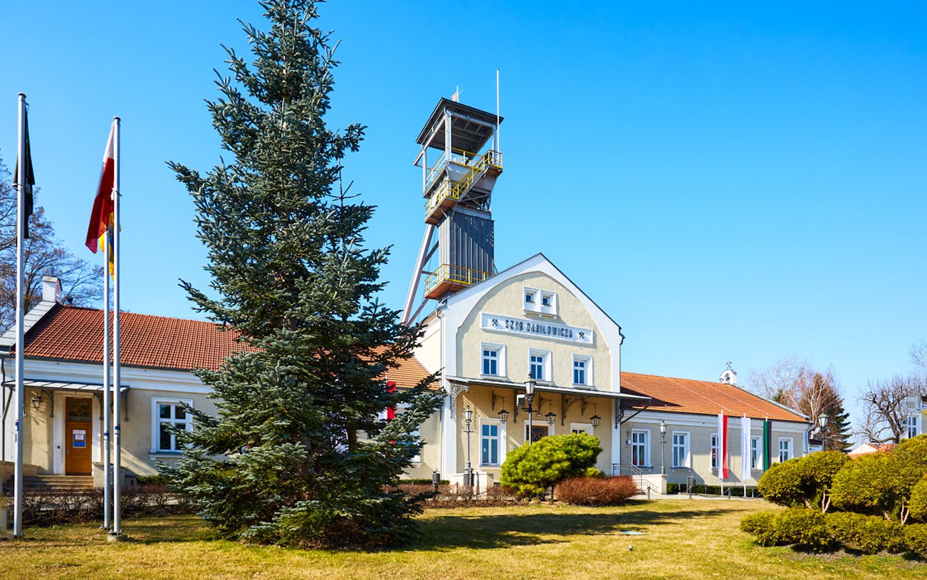 Wieliczka Salt Mine entrance with flags and tower in Poland.