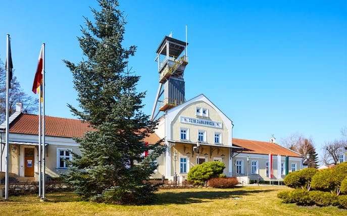 Wieliczka Salt Mine entrance with flags and tower in Poland.