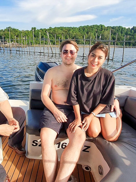 Tourists enjoying a boat ride near a kelong in Singapore.