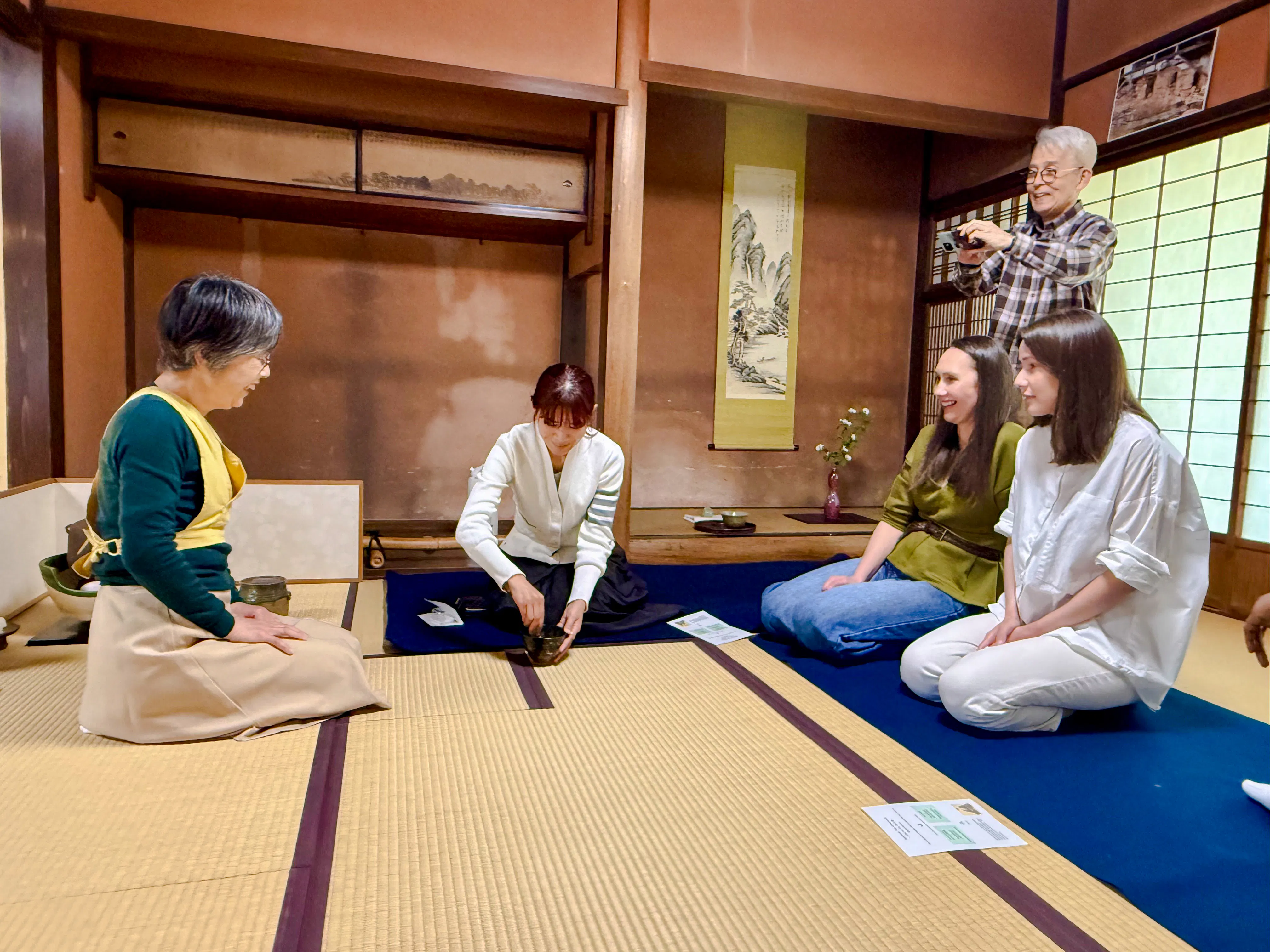 Local tea ceremony at cultural house in Hyogo with participants observing tea preparation.