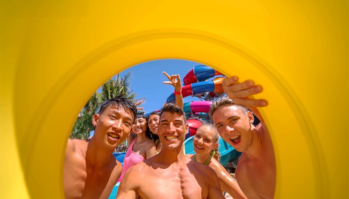 Andamanda Phuket water park slide curving through rocky caverns.