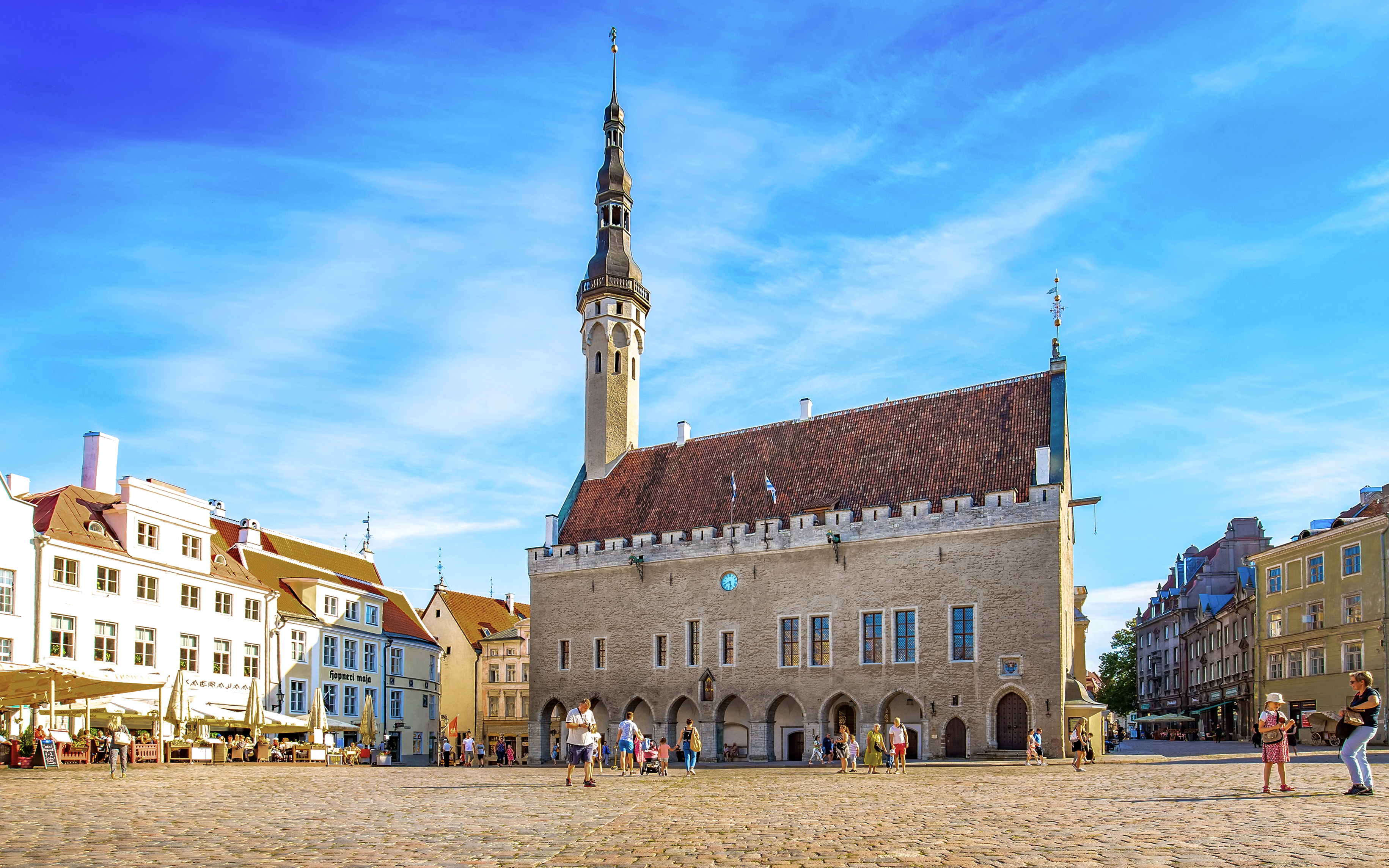 Tallinn Town Hall Square with historic buildings and people, Estonia.