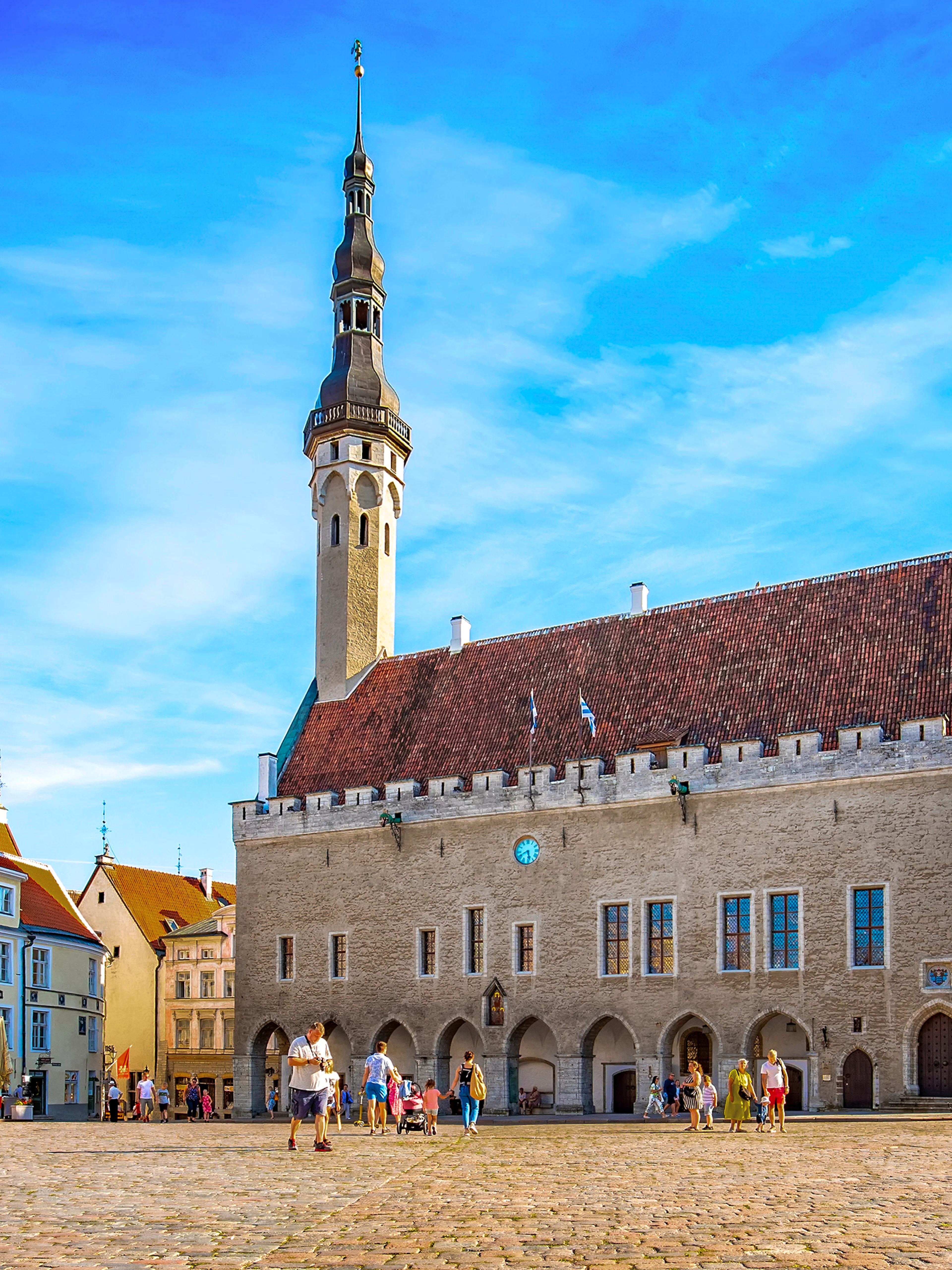 Tallinn Town Hall Square with historic buildings and people, Estonia.