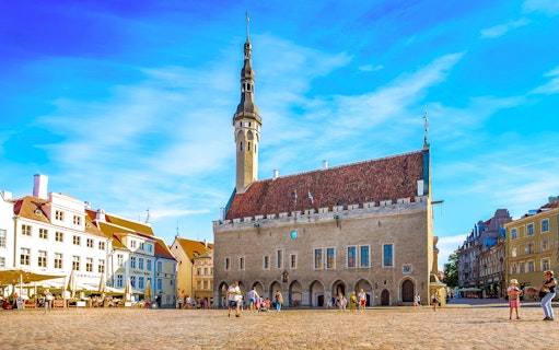 Tallinn Town Hall Square with historic buildings and people, Estonia.
