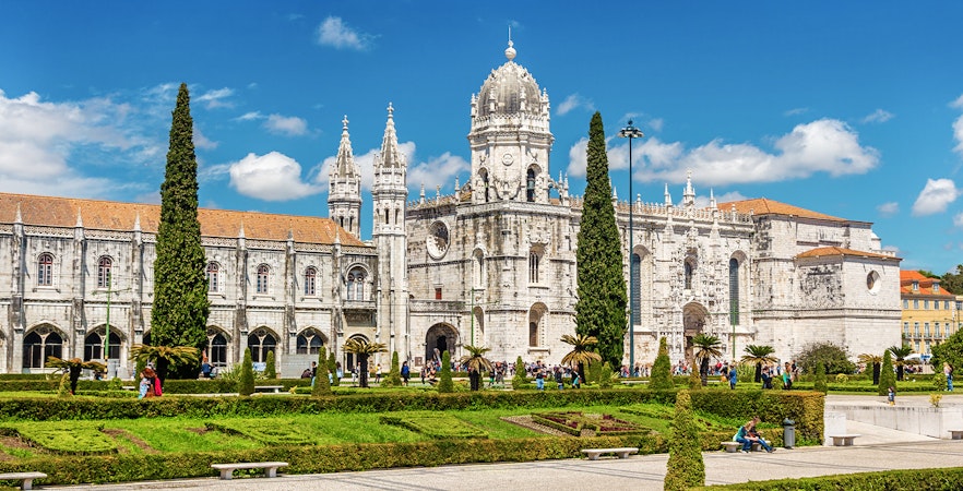 Jeronimos Monastery in Lisbon with ornate architecture and manicured gardens.