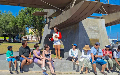 Tourist group with guide near Jeronimos Monastery monument in Lisbon.