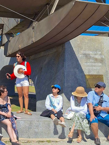 Tourist group with guide near Jeronimos Monastery monument in Lisbon.