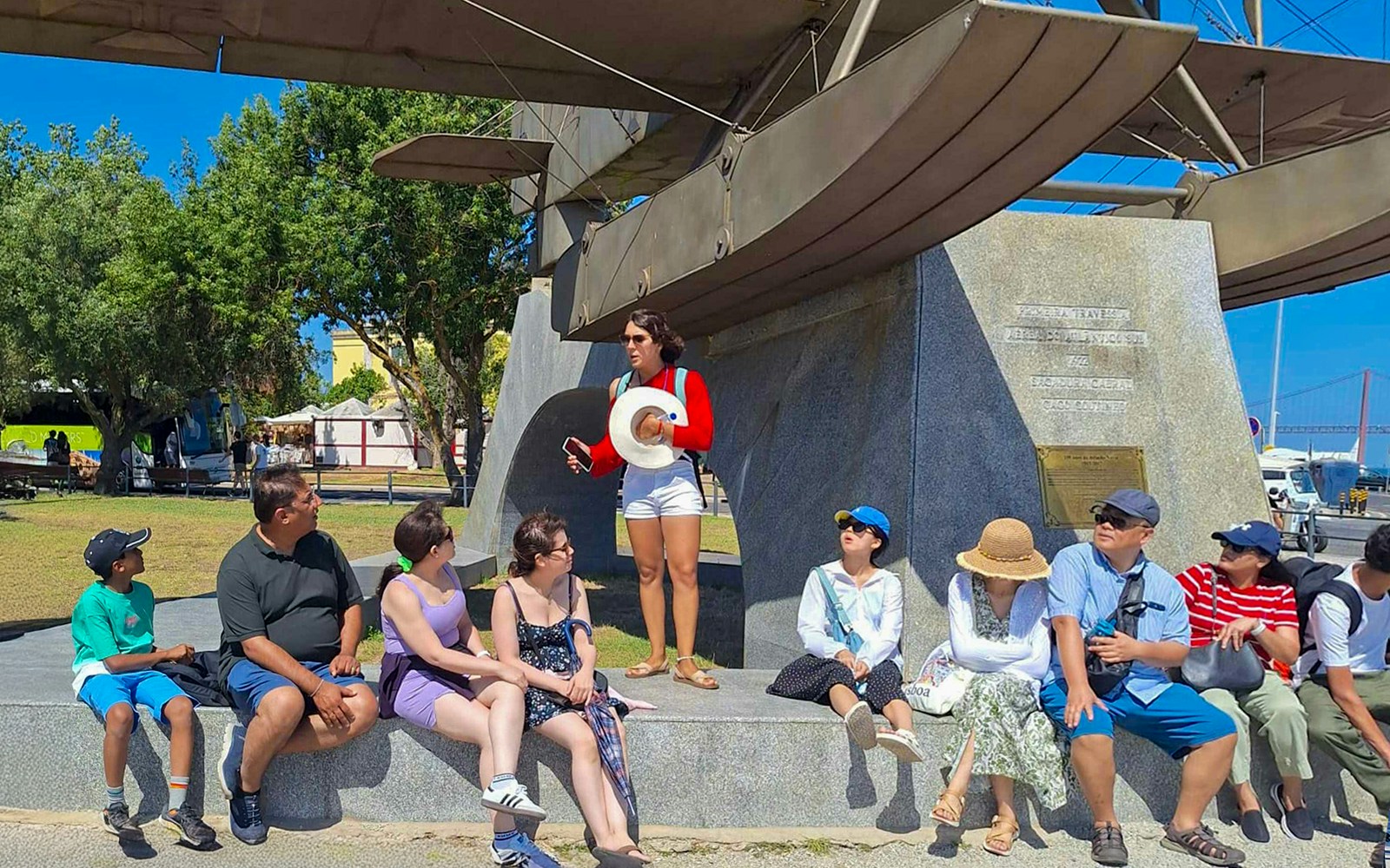 Tourist group with guide near Jeronimos Monastery monument in Lisbon.