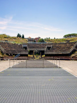 Flavian Amphitheatre of Pozzuoli with ancient stone seating and central arena.