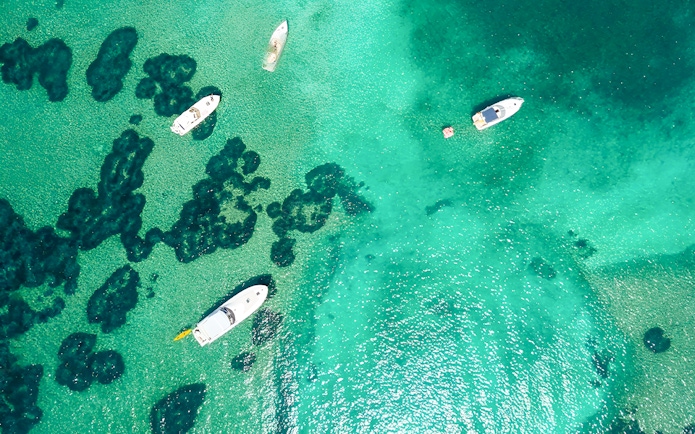 Boats on turquoise waters near Elaphiti Islands, Dubrovnik, during a Blue Cave tour.