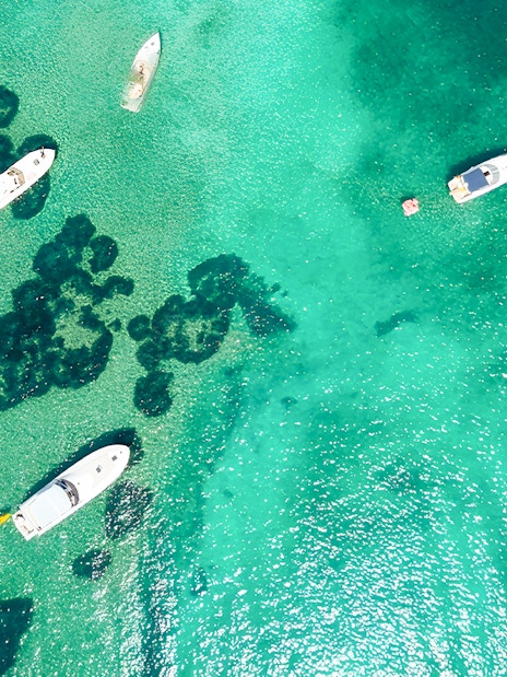 Boats on turquoise waters near Elaphiti Islands, Dubrovnik, during a Blue Cave tour.