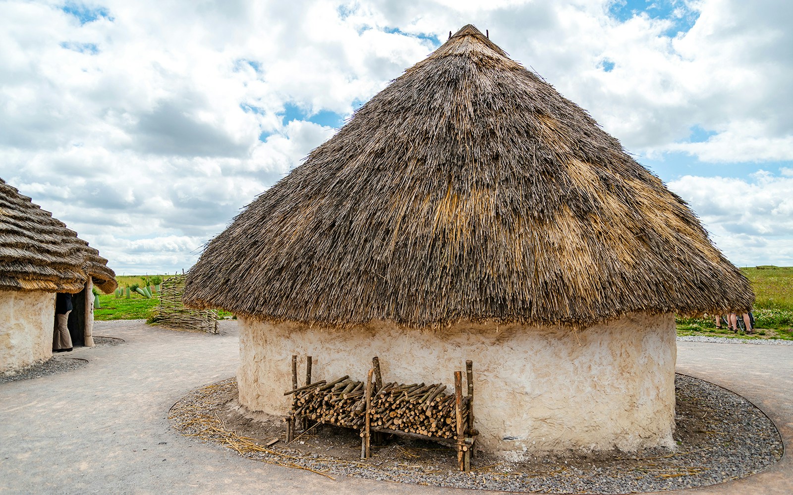 Traditional mud huts with thatched roofs at Stonehenge, England.
