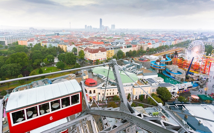View of Vienna from the Giant Ferris Wheel, showing cityscape and amusement park below.