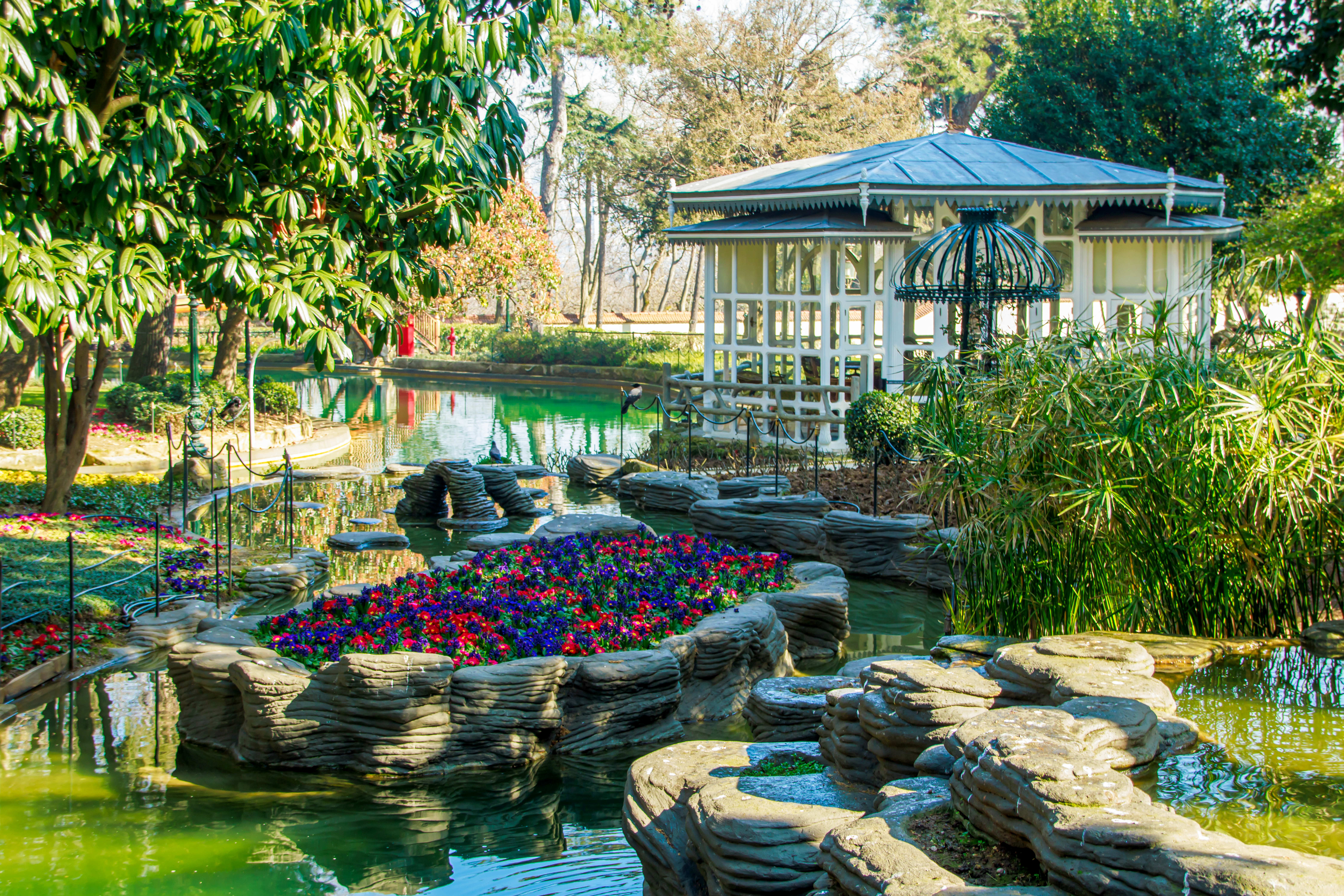 Pool and garden at Yildiz Palace, Istanbul, with flowers and a gazebo.