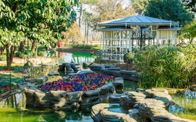 Pool and garden at Yildiz Palace, Istanbul, with flowers and a gazebo.