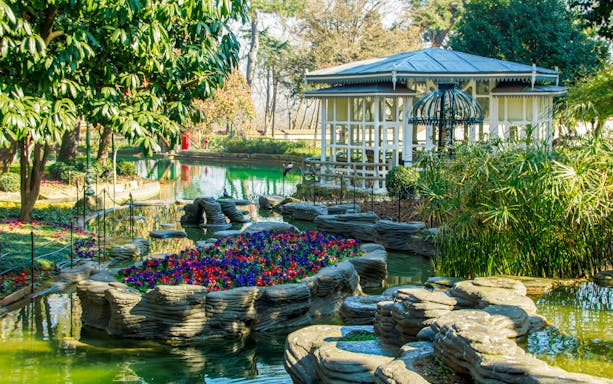 Pool and garden at Yildiz Palace, Istanbul, with flowers and a gazebo.