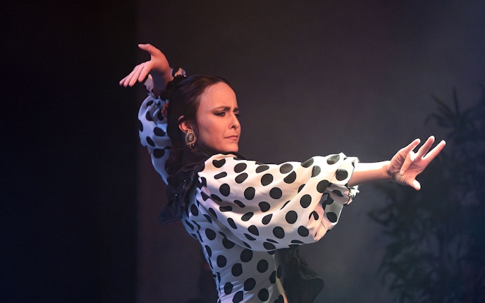 Flamenco dancer performing at Flamenco Laietana in polka dot dress.