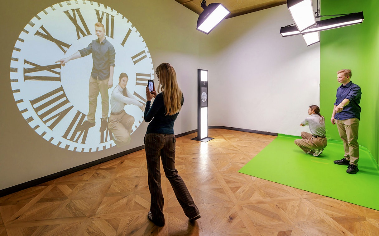 Guests interacting with a clock projection at Praga Magica Interactive Exhibition.