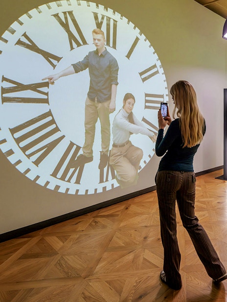 Guests interacting with a clock projection at Praga Magica Interactive Exhibition.