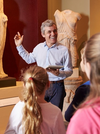 Visitors exploring marine life exhibits at Blue Planet Aquarium, Cheshire.