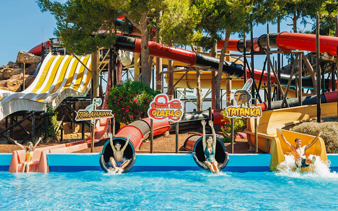 Visitors enjoying the Cola del Diablo water slide at Western Water Park.