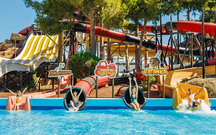 Visitors enjoying the Cola del Diablo water slide at Western Water Park.