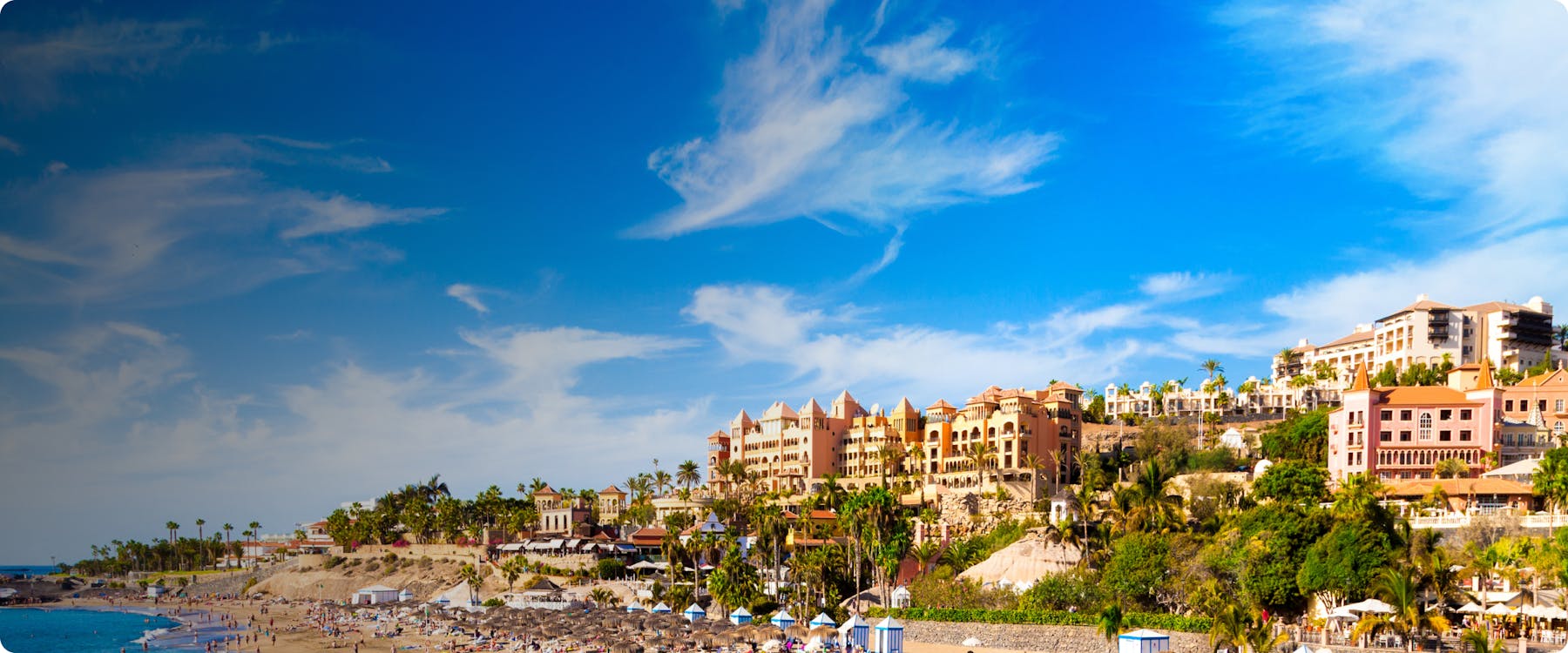Beachfront resorts and sandy coastline in Tenerife, Spain.