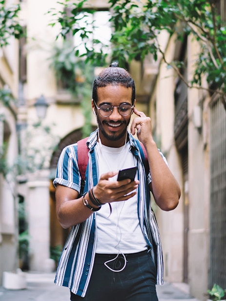 Person using audio guide app in Montmartre, Paris.